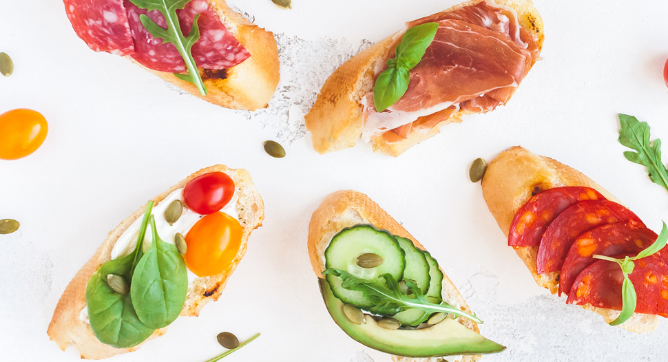 Ham and other ingredients on bread slices as tapas