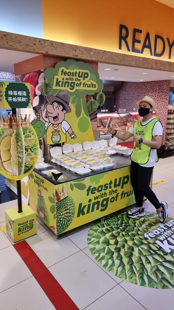 Staff at a durian stand in a store