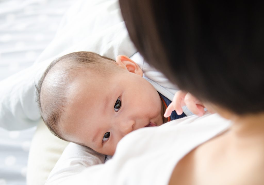 Asian baby breastfed by a young mother