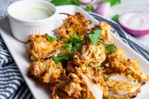 air fried onion pakora served with mint and coriander raita dip