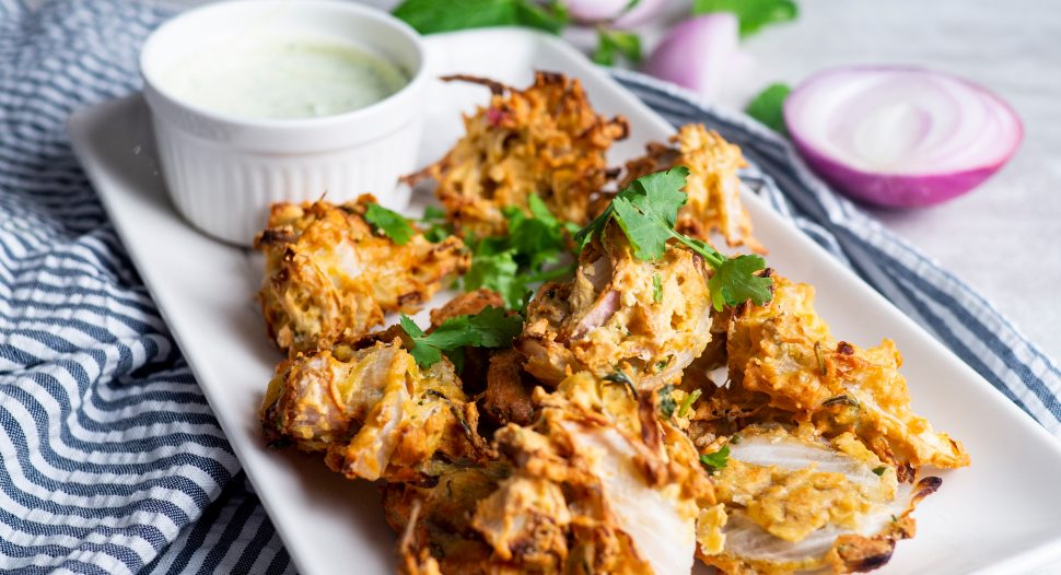 air fried onion pakora served with mint and coriander raita dip