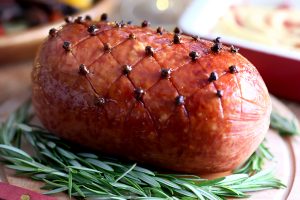 scored christmas ham served with creamy mash and roasted vegetables