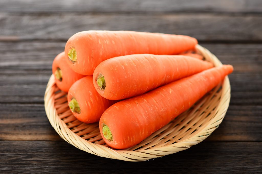 Orange carrots on a weaved plate