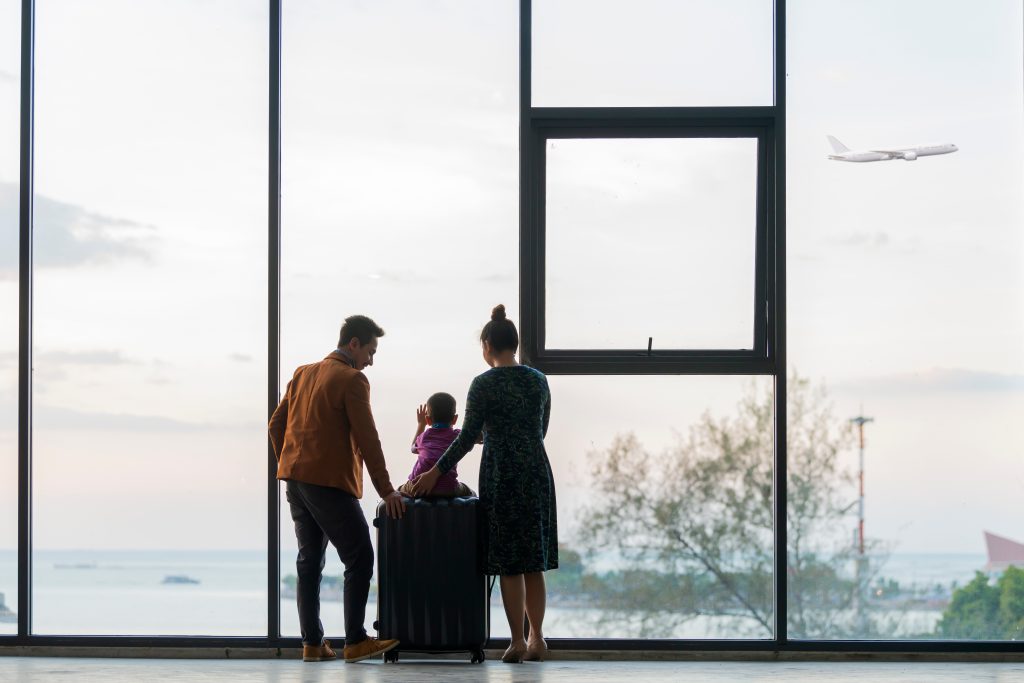Happy,Asian,Family,With,Suitcases,In,The,Airport.,Little,Boy
