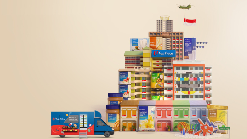 FairPrice National Day Block Party Blocks of colourful HDB flats with FairPrice Housebrand products set amongst them, and a FairPrice on Wheels truck in the foreground