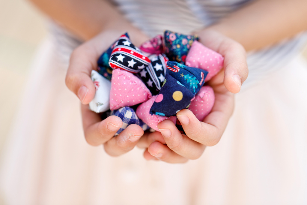 Five stones Close up of a girl's hands holding a bunch of colourful five stones