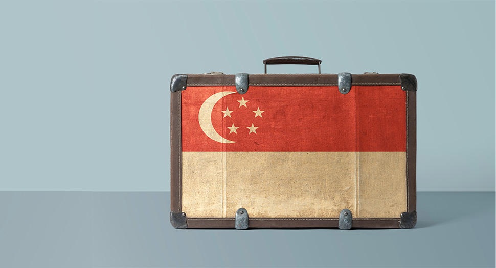 The Singapore flag on the face of an old vintage leather suitcase